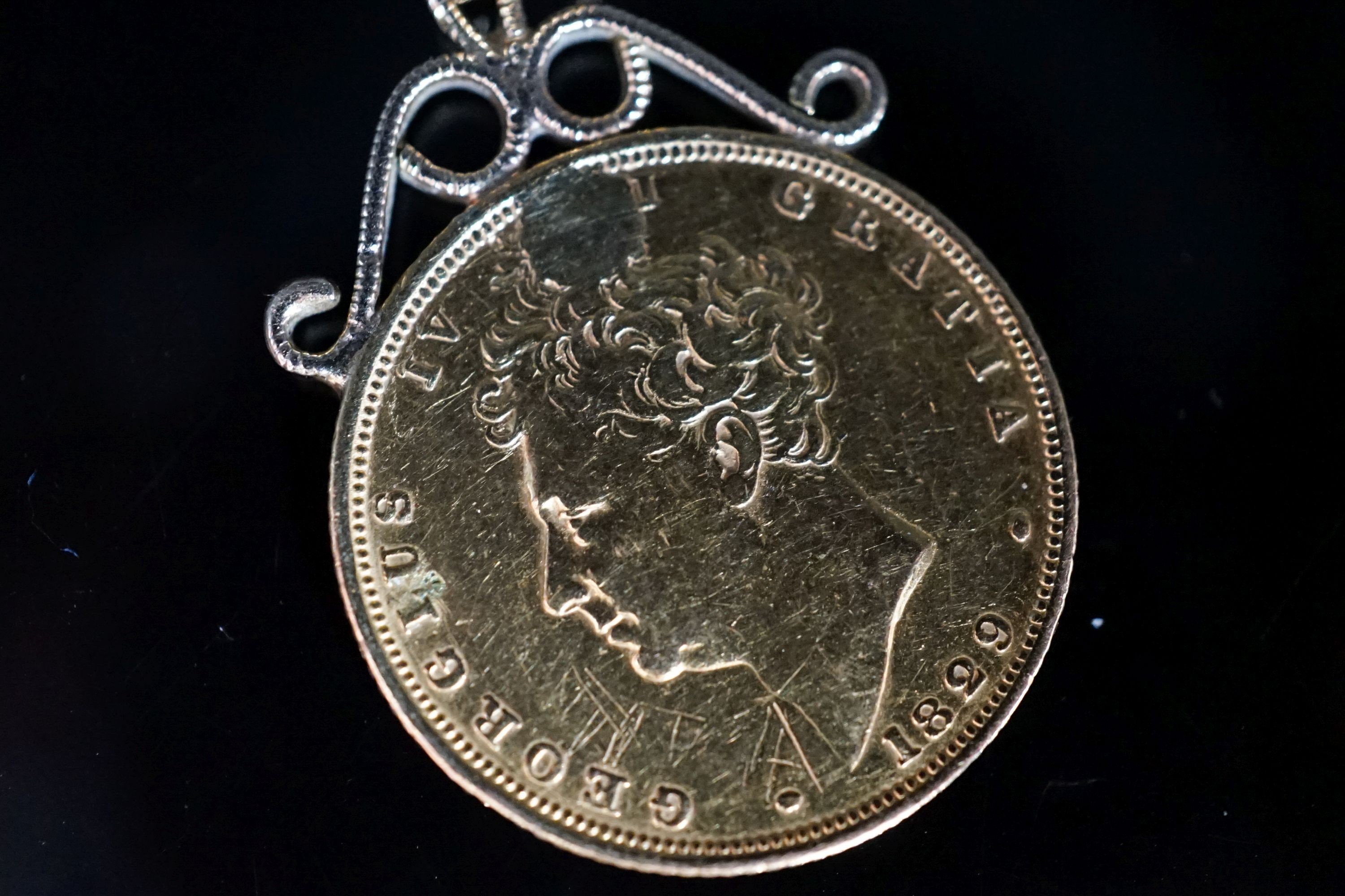 A George IV 1829 sovereign, now with pendant mount, gross 8.6 grams.